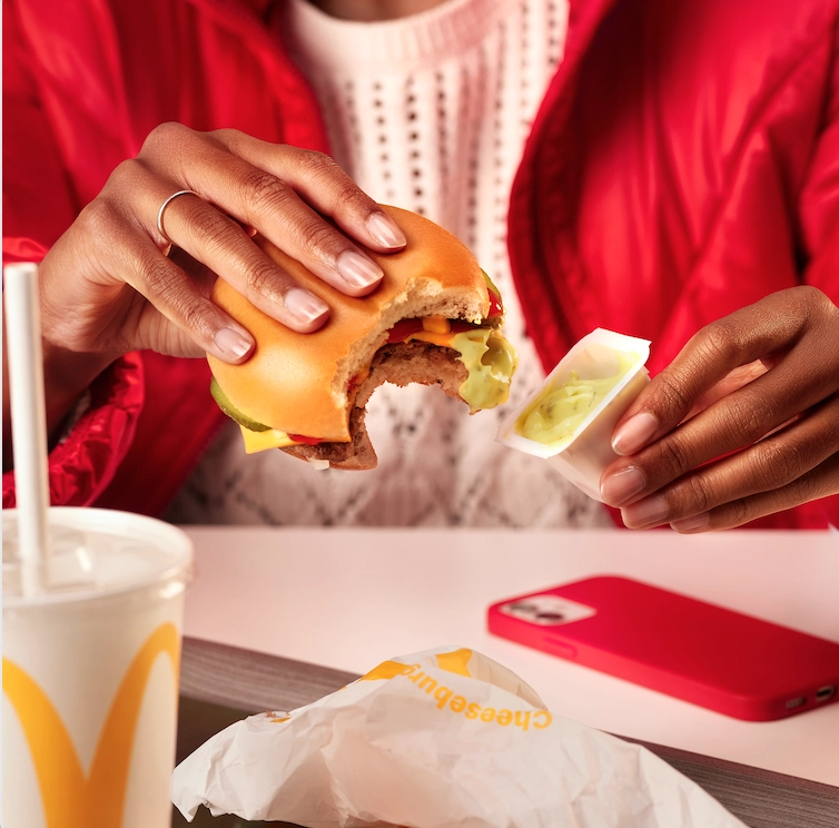 Person eating a Cheese burger for a Mc Donalds food styling photoshoot  by Sander de Ponti and No Points Studio's
